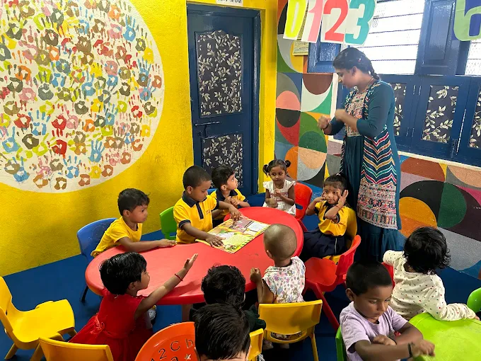 Teacher engaging with children in a colorful classroom